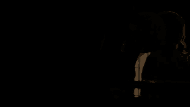a woman in a white dress stands in the dark