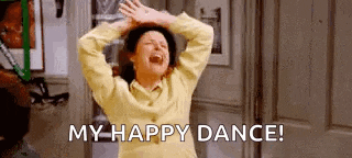 a woman is laughing and saying `` my happy dance '' while holding her hands up in the air .