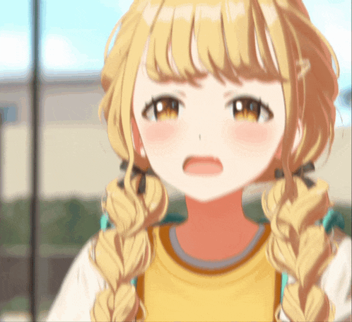 a close up of a girl with blonde hair making a funny face
