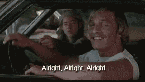 a man is driving a car with a woman sitting in the back seat .