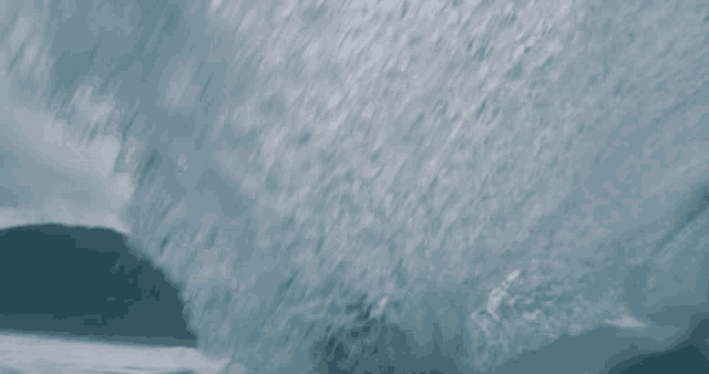 a close up of a wave breaking on a rock