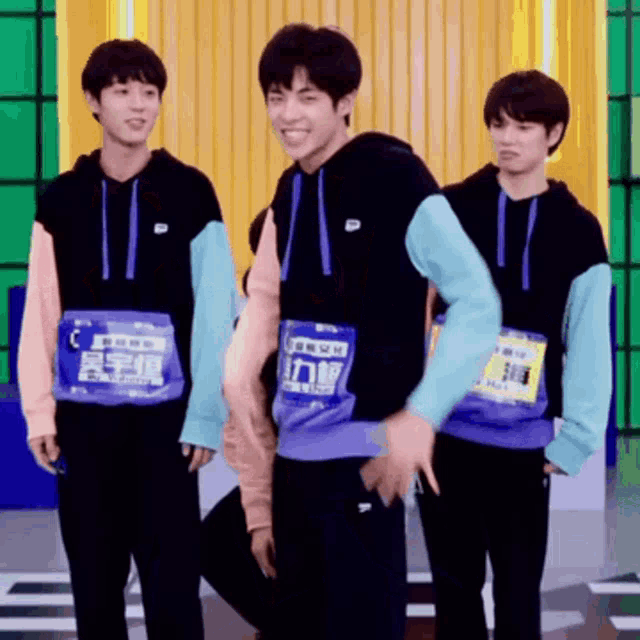 a group of young men are standing next to each other and one of them is wearing a shirt that says ' a '