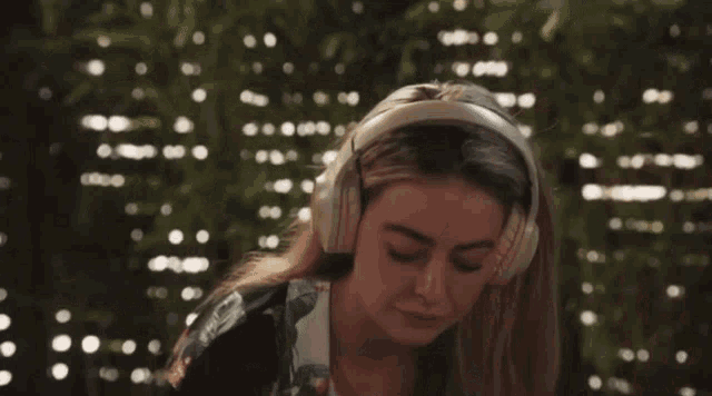 a woman wearing headphones with a blurry background of lights