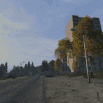 a blurred image of a street with a tall building in the background