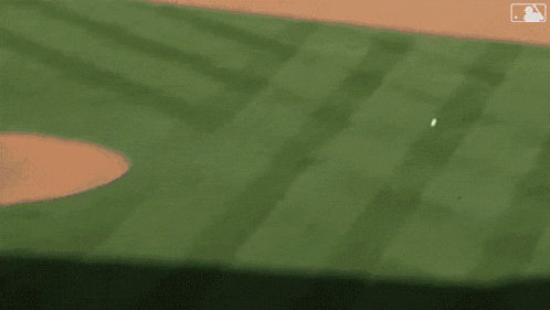 a blurry picture of a baseball game with the mlb logo