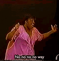 a woman singing into a microphone with the words " no no no no way " above her