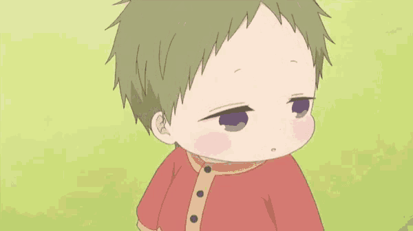a little boy with green hair and a red shirt is standing in a field .