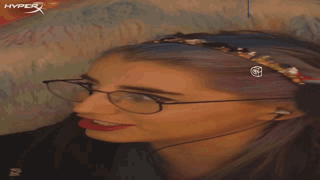 a woman wearing glasses and a headband with a hyper logo on it