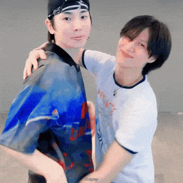 two young men are hugging each other and one of them is wearing a shirt that says always