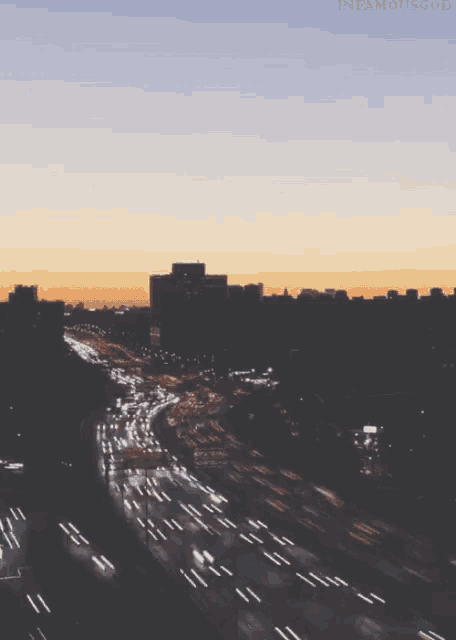 an aerial view of a city at sunset with the words infamousgood visible in the upper right corner