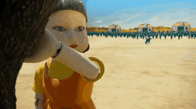 a group of people are playing a game with a doll in the background
