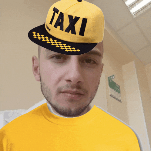 a man wearing a yellow hat with taxi written on it