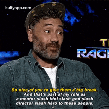 a man wearing a hat and a denim shirt is talking about a big break .
