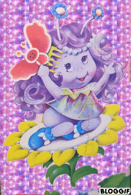 a girl with a butterfly on her head is sitting on a flower with the words bloggif below her