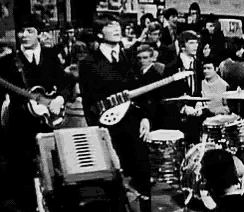 a black and white photo of a group of people playing instruments .