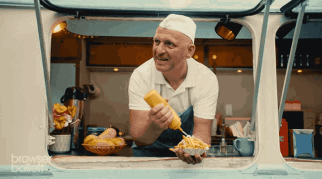 a man holding a bowl of french fries in front of a window that says " browser ballet "