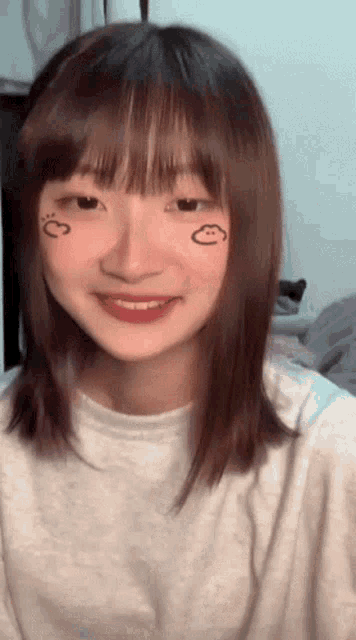 a young girl with a cloud drawn on her face