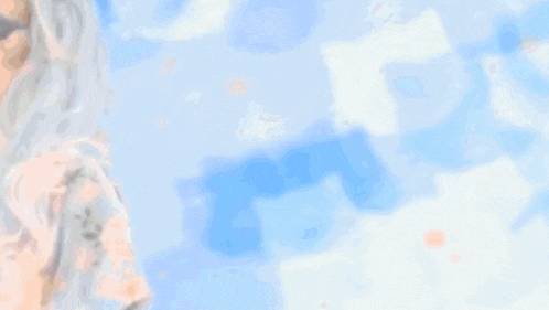 a blurry picture of a woman with white hair and a blue background