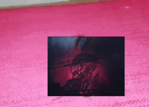 a pink carpet with a picture of a man in the background