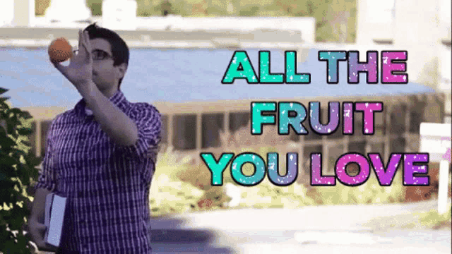 a man in a plaid shirt is holding an orange in his hand with the words all the fruit you love behind him