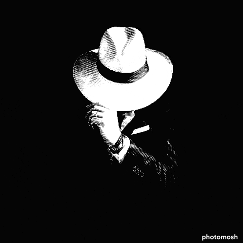 a black and white image of a man wearing a hat