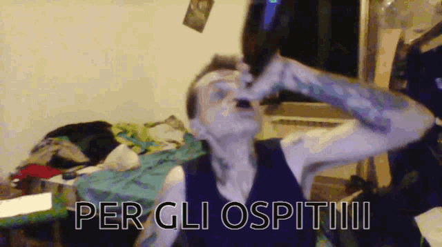 a man is drinking from a bottle with the words per gli ospitiii written on the bottom