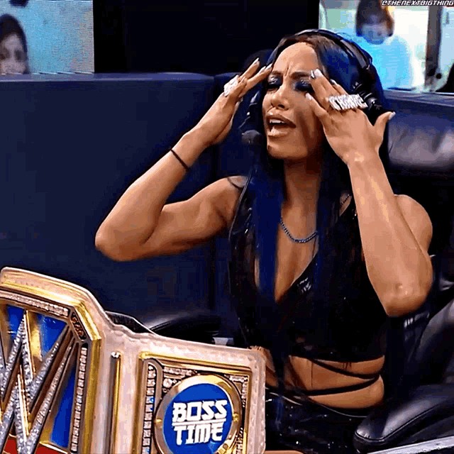 a woman sitting in a chair with a boss time belt