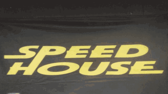 a black banner with yellow letters that reads speed house