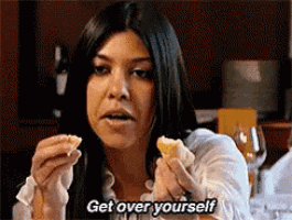 a woman is eating a piece of food and says get over yourself .