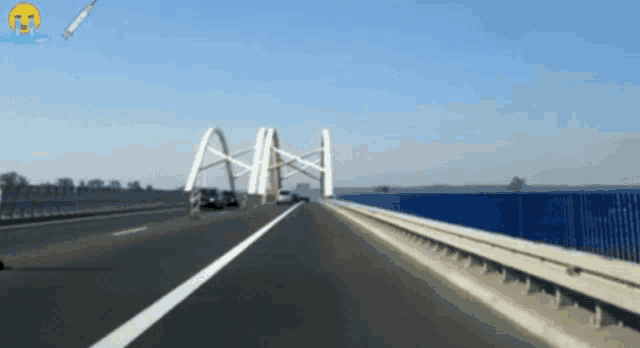 a car is driving on a highway with the letter a on the bridge