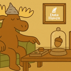 a moose is sitting in a chair in front of a sign that says " data haven "