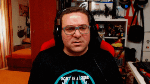 a man wearing headphones and a shirt that says ' don t be a loser '