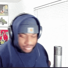 a man wearing headphones and a headband with the letter n on it