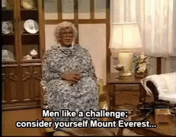 a woman is sitting in a chair talking about men like a challenge