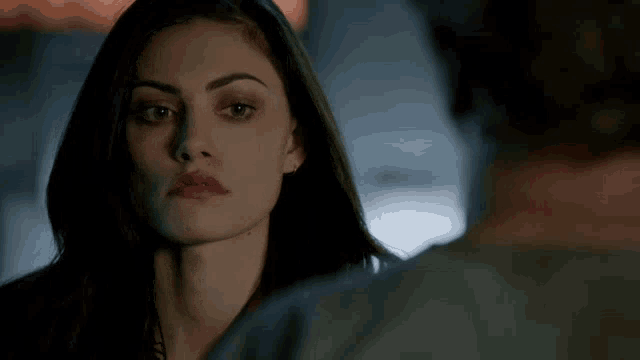 a close up of a woman 's face looking at a man