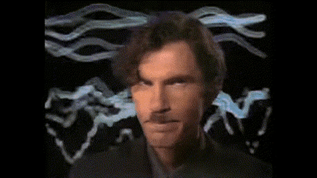 a close up of a man 's face with smoke coming out of his head