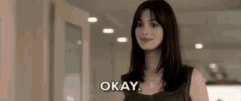 a woman is smiling and saying okay .