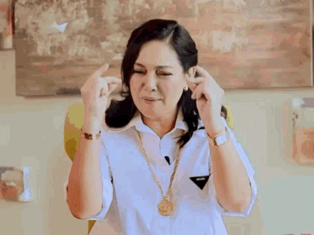 a woman in a white shirt is making a heart shape with her hands and the word fighting is written above her .