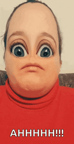 a woman is wearing a red turtleneck and making a funny face with big eyes .