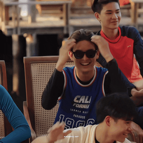 a man wearing sunglasses and a blue jersey that says cali fornia