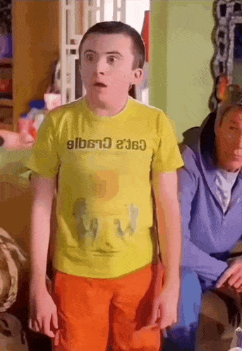 a boy wearing a yellow t-shirt that says ' gilberto ' on it