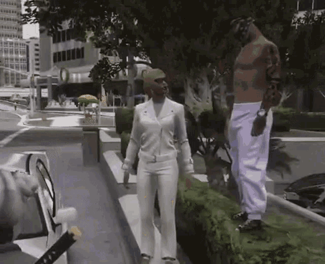 a man and a woman are standing next to each other on the sidewalk in a video game .