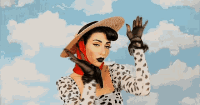 a woman wearing a straw hat and sunglasses is pointing