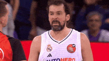 a man with a beard is wearing a white jersey with the word autohero on it