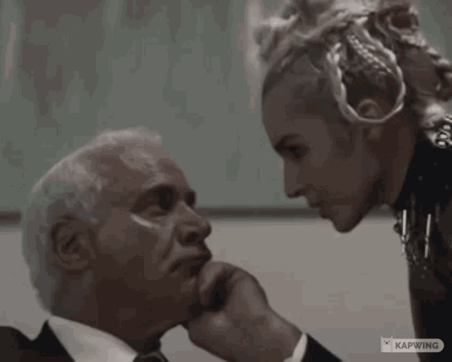 a man and a woman are looking at each other with the caption kapwing in the corner