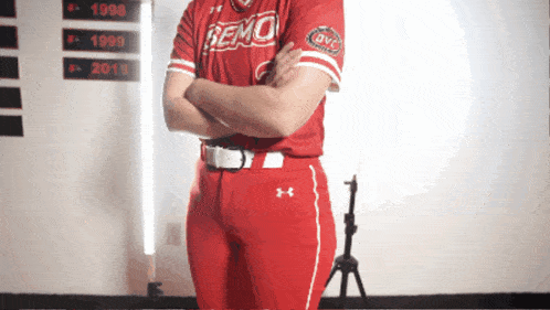 a person wearing a red remo jersey with their arms crossed