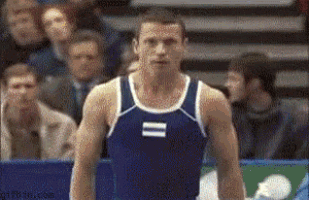 a man in a blue tank top with the number 11 on it is standing in front of a crowd .
