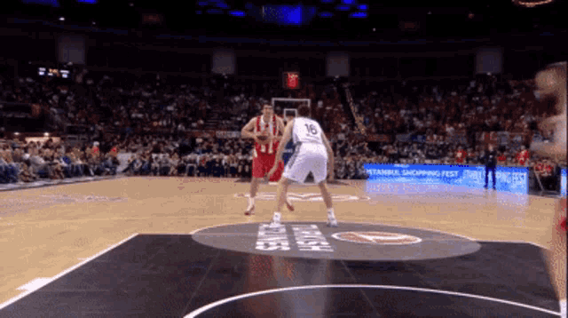 a basketball game is being played in front of a crowd with a sign that says istanbul shopping fest