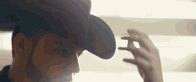 a close up of a man wearing a hat and a beard