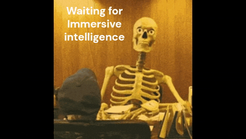 a skeleton sits at a desk with the words " waiting for immersive intelligence "